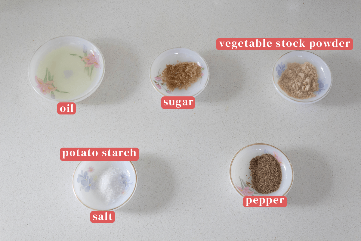 Dishes of oil, sugar, vegetable stock powder, pepper, salt and potato starch.