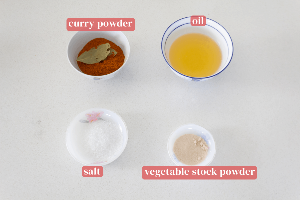 Bowls of curry powder, oil, vegetable stock powder and salt.